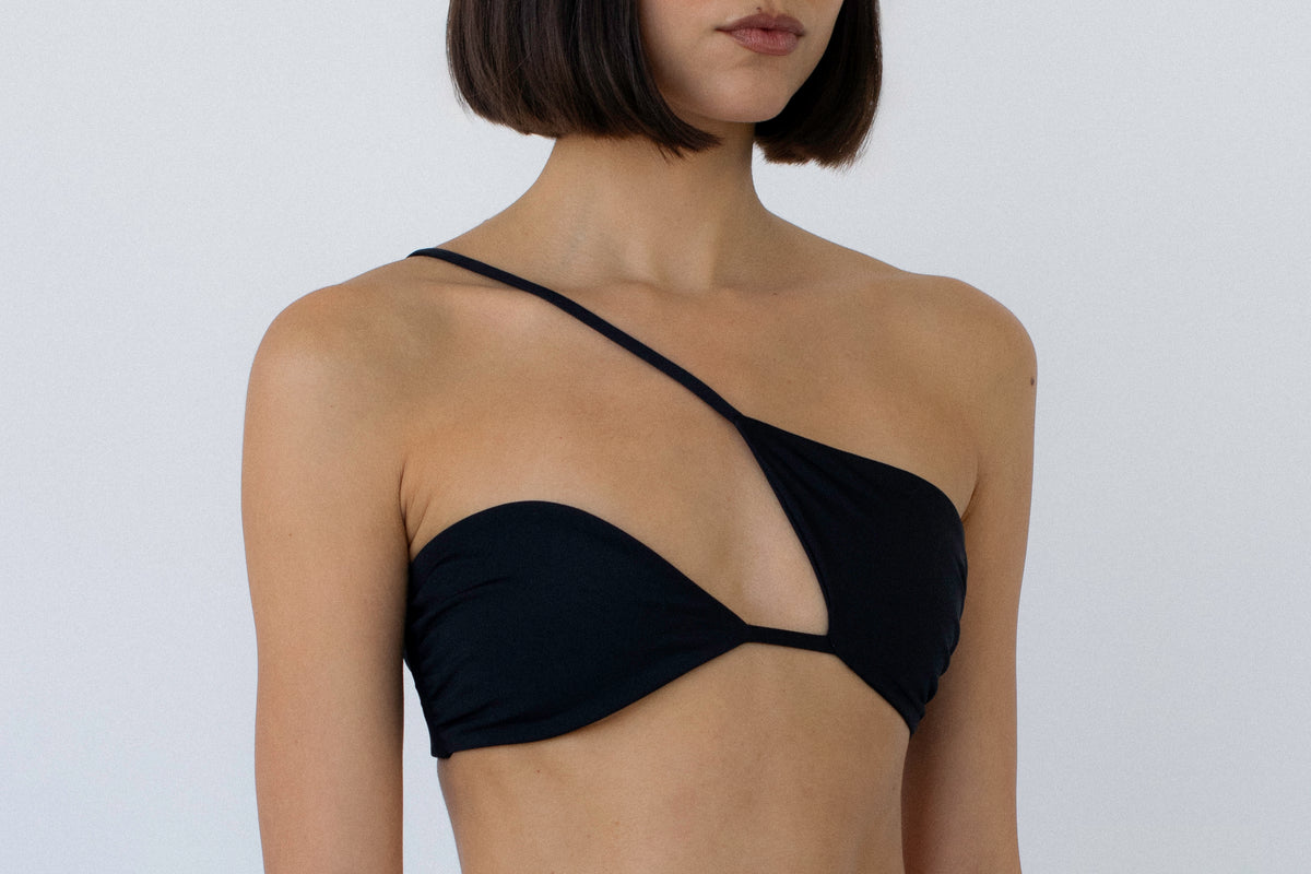 model wearing a black asymmetrical bikini top