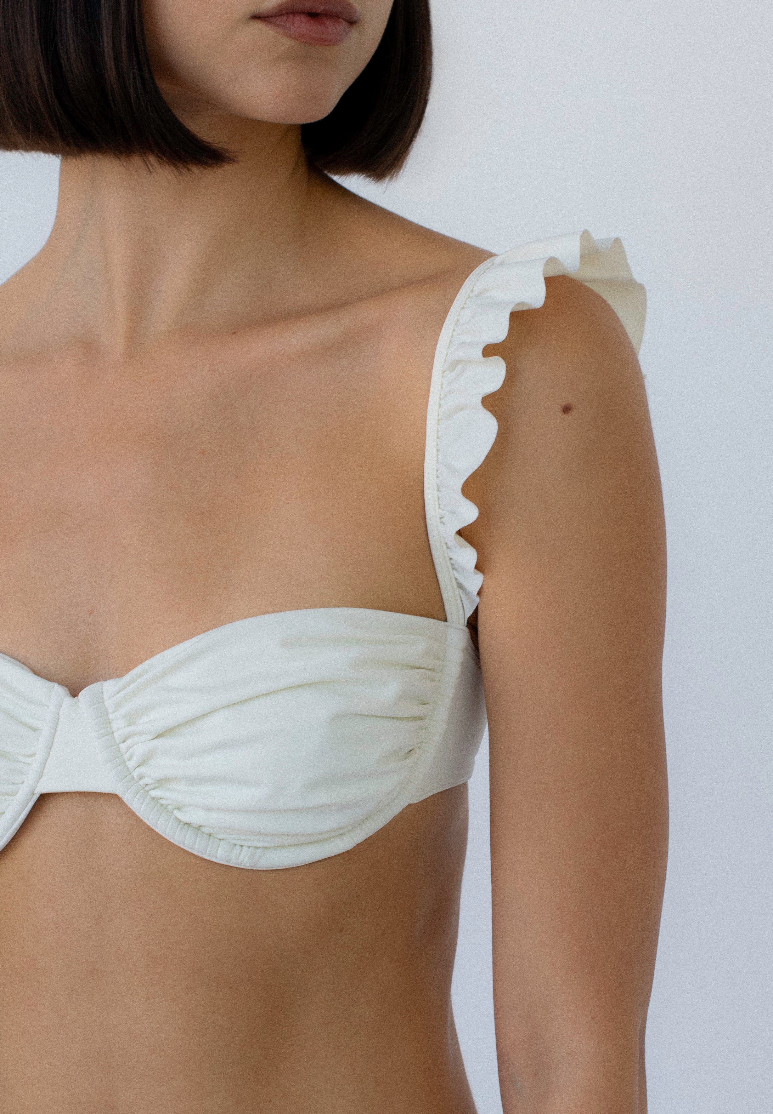 ruffled balconette bikini top in ivory on model