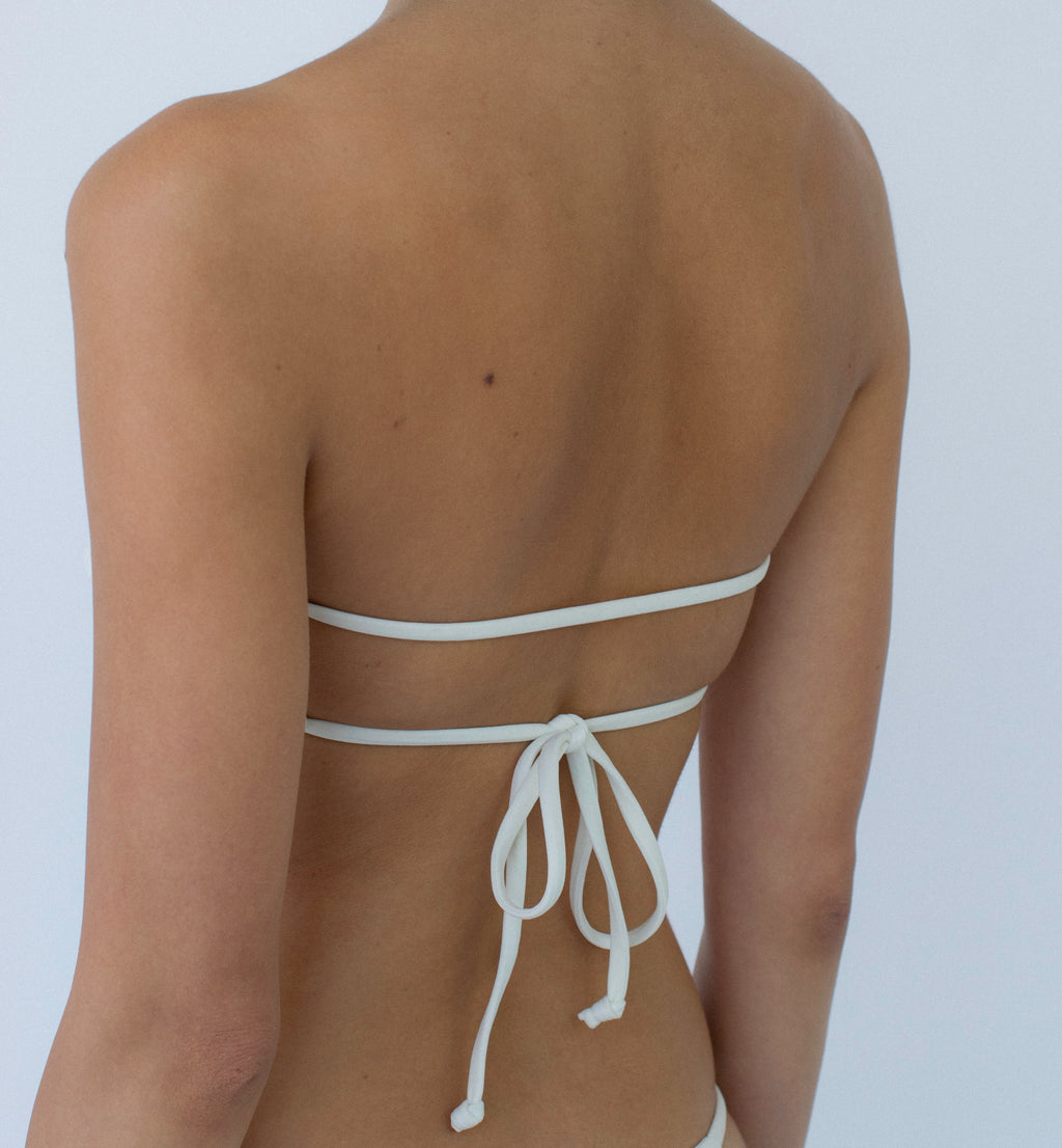 ivory twisted bandeau bikini top on model