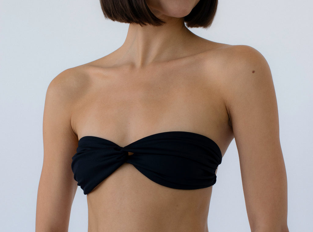 black twisted bandeau bikini top on model